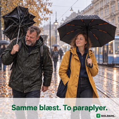 Mand med itu paraply og kvinde med Stormparaplyet på en blæsende gade i regn